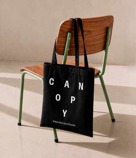A Canopy tote bag handing on a chair in the workspace